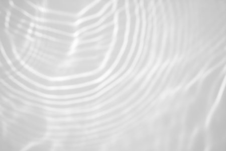 blurred shadow and light caustic effect on a white wallの写真素材