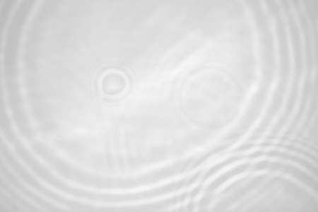 blurred shadow and light caustic effect on a white wallの写真素材