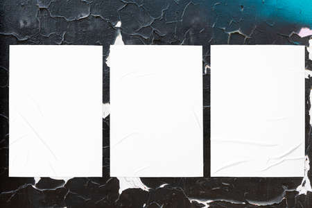 colorful urban wall texture with three wrinkled glued poster templatesの写真素材