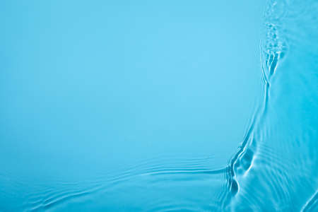 Transparent blue colored clear water surface texture with ripples, splashes and bubbles. Abstract nature background Water waves in sunlight with copy space Cosmetic moisturizer micellar toner emulsionの写真素材