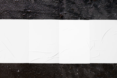 black urban wall texture with four wrinkled glued poster templatesの写真素材