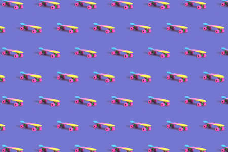 Pattern made of rainbow plastic skateboard on purple backgroundの写真素材
