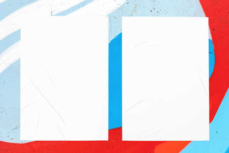 colorful urban wall texture with two wrinkled glued poster templatesの写真素材