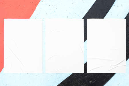 colorful urban wall texture with three wrinkled glued poster templatesの写真素材