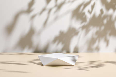 scene with polygonal podium on beige background and shadowsの写真素材