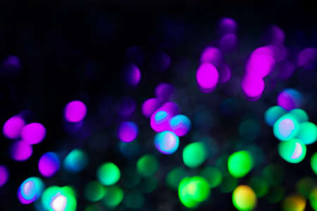 Purple and green circles bokeh festive glitter dark background