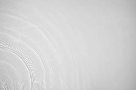 desaturated transparent clear calm water surface textureの写真素材