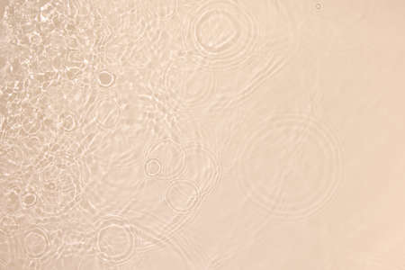 transparent beige colored clear calm water surface textureの写真素材