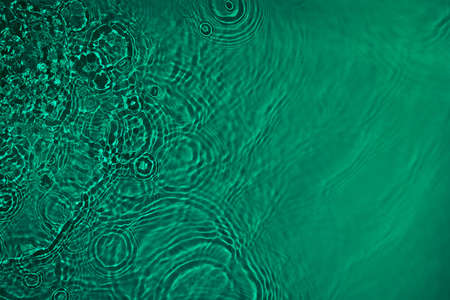 transparent dark green colored clear calm water surface texture