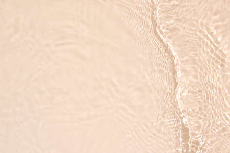 transparent beige colored clear calm water surface textureの写真素材