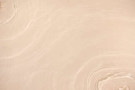transparent beige colored clear calm water surface texture