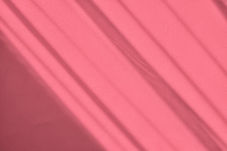 Shadow and light on solid pink wall texture backgroundの写真素材