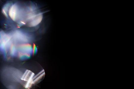 colorful rainbow crystal light leaks on black backgroundの写真素材