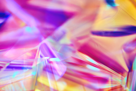 bright neon pink, purple, orange holographic metallic foil festive backgroundの写真素材