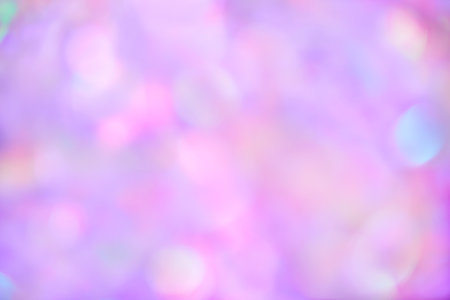 Blurred pastel neon purple, pink holographic bokeh background textureの写真素材