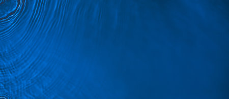transparent dark blue colored clear calm water surface textureの写真素材