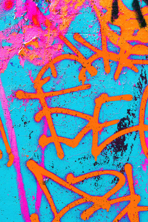 close up of colorful teal, pink, blue, green urban wall texture
