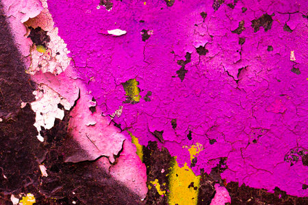 Vibrant Cracked Paint Texture in Neon Pink and Yellow for Retro 80s Designの写真素材