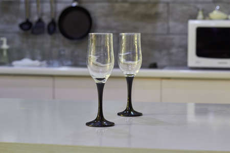 Champagne glasses on the table in a beautiful modern kitchenの写真素材