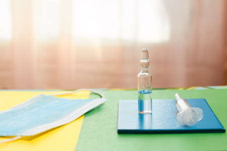 Great photo with the concept of fighting the pandemic. Vaccination passport, syringe, vaccine, face...