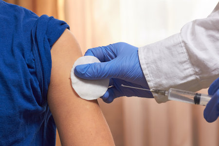 A doctor injecting vaccine to the patient