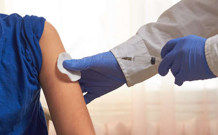 The doctor vaccinates the vaccine against viruses. the fight against the epidemic.の写真素材