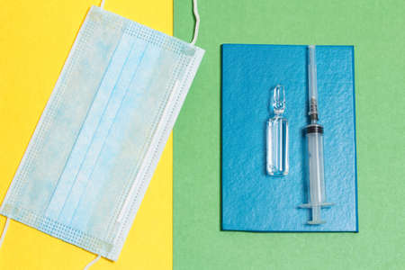 Great photo with the concept of fighting the pandemic. Vaccination passport, syringe, vaccine, face maskの写真素材