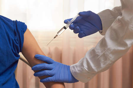 An orderly inoculates a vaccine against viruses. fighting the epidemic vaccination.の写真素材