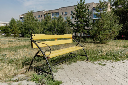 the old bench is located in the park next to the house.の写真素材