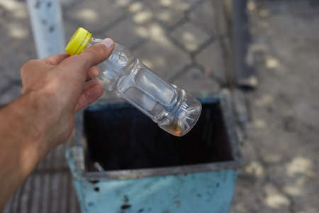 Throw the garbage in the trash taking care of cleanliness.の写真素材