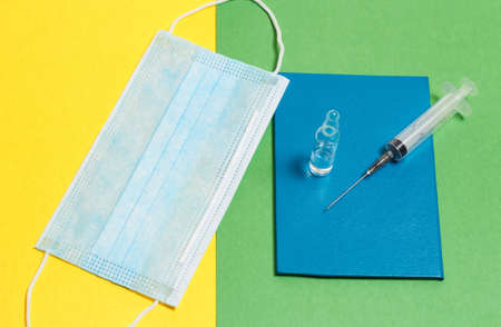Great photo with the concept of fighting the pandemic. Vaccination passport, syringe, vaccine.の写真素材