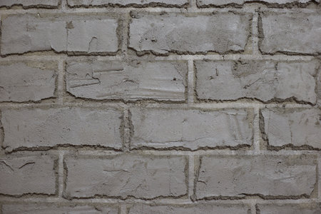 Gray wall in the form of brickwork repair and decoration of walls, taken close-up.の写真素材