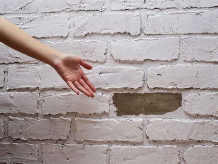 Decorative plaster tiles on the wall imitation of brick fell breakdown poor repair.の写真素材