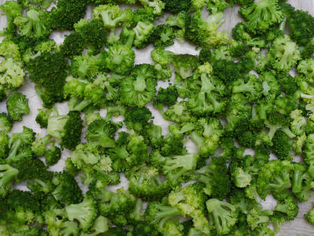 Cooked broccoli is lying on the table, filmed as a background of a vegetable.の写真素材
