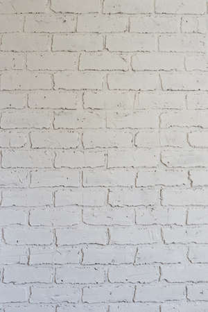 Decorative plaster on the wall in the form of white brickwork can be used as a background.の写真素材
