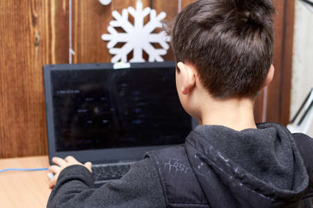 Little boy gamer plays on the computer, playing a lot is harmful.の写真素材