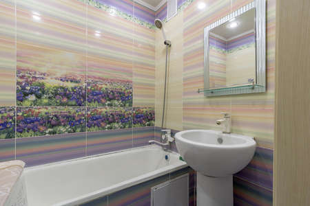 Bathroom with bathtub, mirror, toilet and sink, a very important room in any home.の写真素材