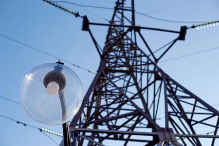 Electric tower for energy transmission there is a street lamp nearby without light there is no...