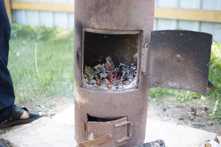 rusty oven for cooking Uzbek pilaf, heated by burning wood.の写真素材