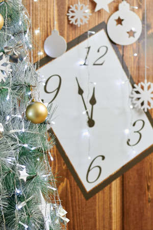 Christmas background with clock, snow fir tree and gift boxes over wood.の写真素材
