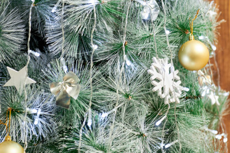 Christmas green tree covered with snow and New Year's toys concept of the New Year holiday.の写真素材