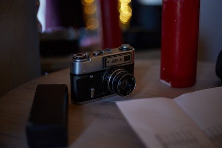 Retro camera on a wooden table in a coffee shop. Selective focus