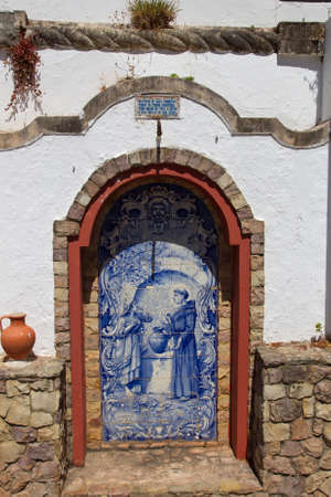 Small altar made   of Azulejos in the Alte - famous village in the Algarve, Portugalの写真素材