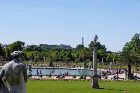 PARIS - JULY 2: People enjoy sunny day in the Luxembourg Garden on July 2, 2014 in Paris. Luxembourg Palace is the official residence of the President of the French Senate.のeditorial素材