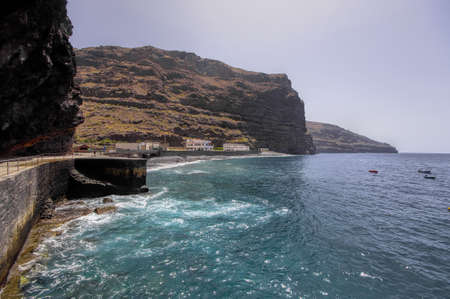 The rocky sea coastline in the destroyed village La Dama, La Gomer island, Canary, Spainの写真素材