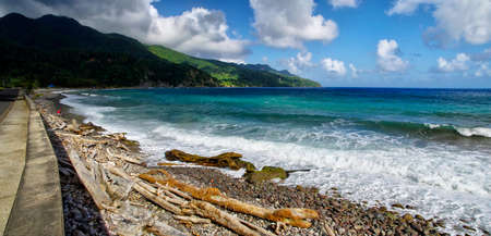 BEREKUA, DOMINICA - JANUARY 6, 2017: The man collects shells on the beach in the Berekua village on January 6, 2017. Lesser Antillesのeditorial素材