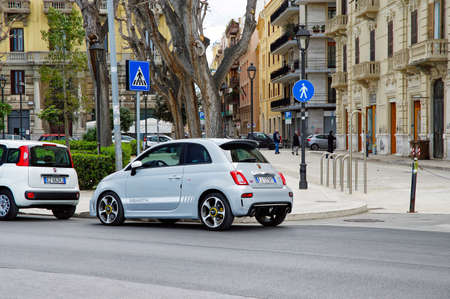 BARI, ITALY - APRIL 1, 2018: Blue Fiat 500 parked in Lungomare Nazario Sauro seafront promenade....