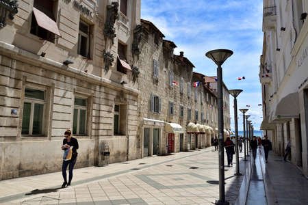 SPLIT, CROATIA - APRIL 29, 2019: A crowd of tourists walking down the main street of Marmontova in Split in early spring, Croatiaのeditorial素材