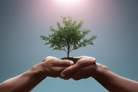 Human hands holding a tree growing from soil. Save the world conceptの素材
