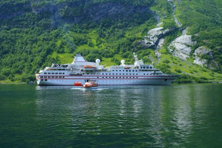 White tuorist ship and mountain landscape with the waterfalls  の写真素材